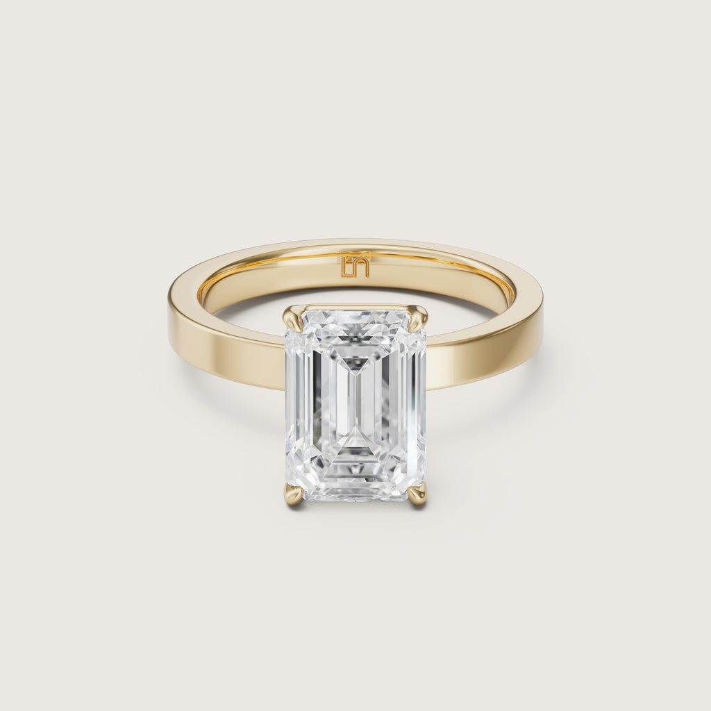 Gold ring with a large emerald-cut diamond on yellow gold 