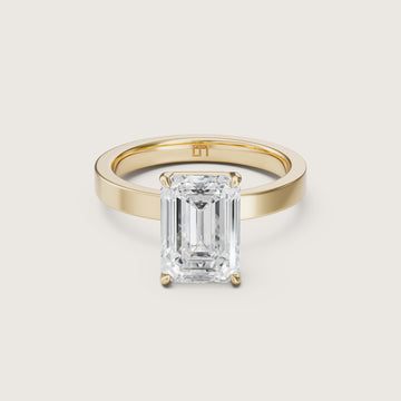 Gold ring with a large emerald-cut diamond on yellow gold 