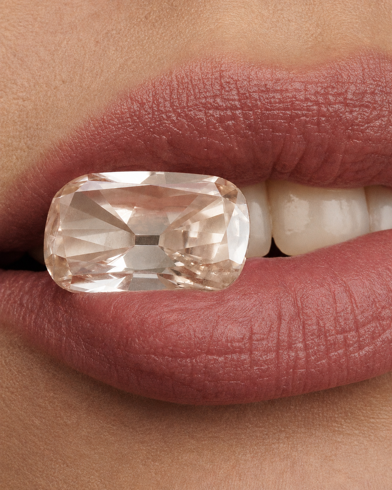 A close-up of a LINDELLI custom designed and cut 10 carat champagne diamond in model's mouth high end jewellery photography 
